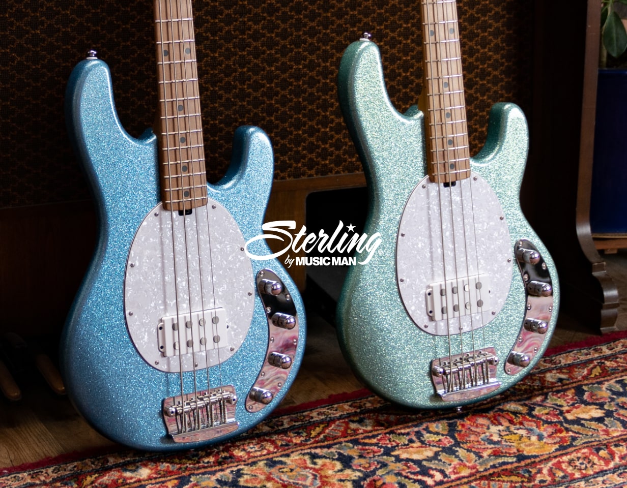 Two sparkly basses with Sterling by Music Man logo overlaid